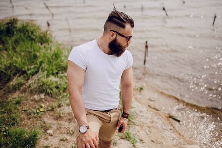 bearded man on the beach on summer dayの写真素材