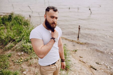 bearded man on the beach on summer dayの写真素材