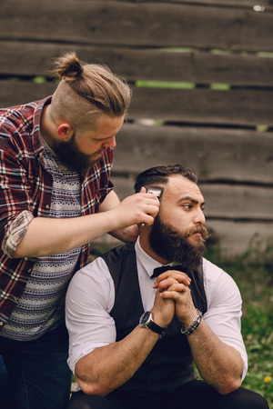 two bearded men shave outdors on summer dayの写真素材