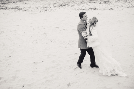 charming wedding couple celebrate their wedding day in Odessa winterの写真素材