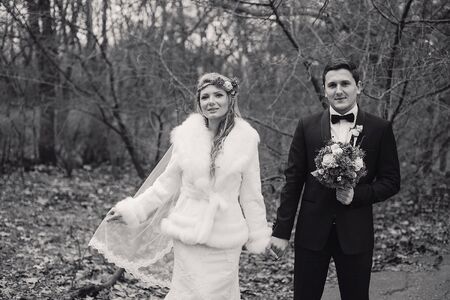 charming wedding couple celebrate their wedding day in Odessa winterの写真素材