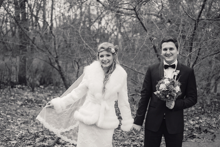charming wedding couple celebrate their wedding day in Odessa winterの写真素材