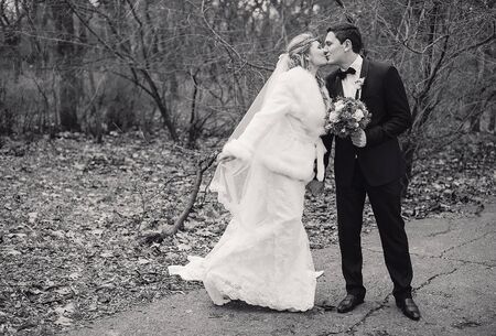 charming wedding couple celebrate their wedding day in Odessa winterの写真素材