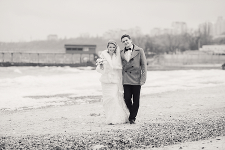 charming wedding couple celebrate their wedding day in Odessa winterの写真素材