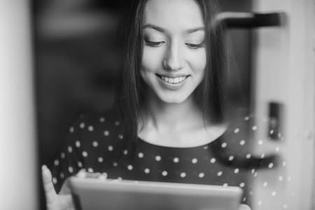 beautiful young girl enjoys phone and tabletの写真素材