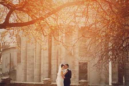 Happy couple whose wedding photo shoot in a golden autumnの写真素材