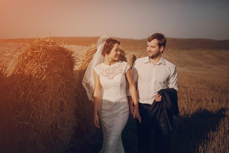 Happy couple whose wedding photo shoot in a golden autumnの写真素材
