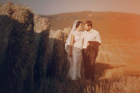 Happy couple whose wedding photo shoot in a golden autumnの写真素材