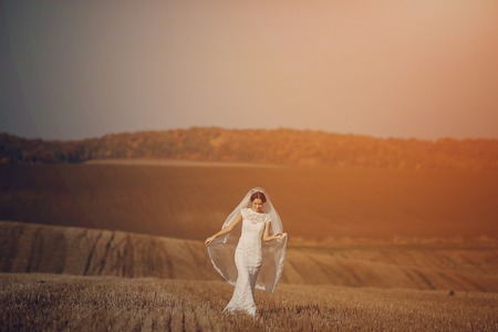 Happy couple whose wedding photo shoot in a golden autumnの写真素材