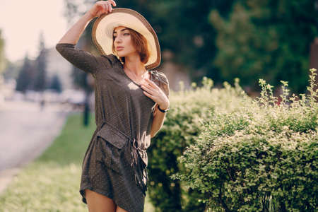 beautiful young model standing in a hat outdoorsの写真素材