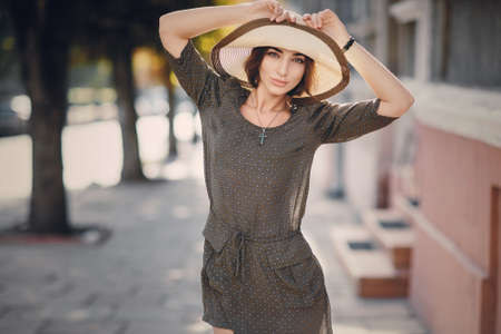 beautiful young model standing in a hat outdoorsの写真素材