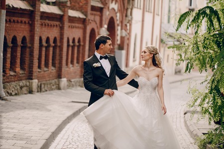 lovely wedding couple walking on their wedding dayの写真素材