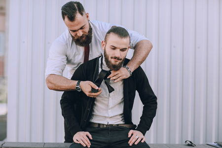 Two bearded men zavyazuyut hastuky each other outの写真素材