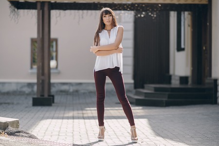 beautiful young model walks the city in summerの写真素材