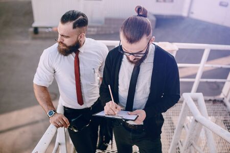 business man checking objects in glasses shirtの写真素材
