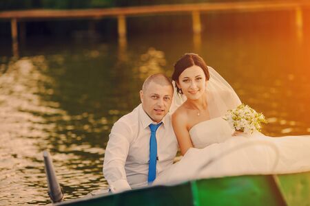 beautiful young couple in wedding sunny summer dayの写真素材