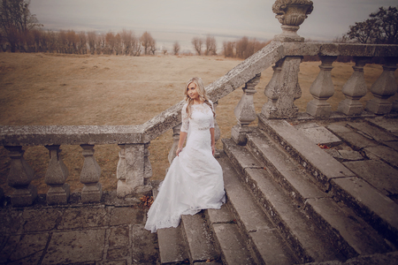 bride walking in golden autumn nature weddingの写真素材