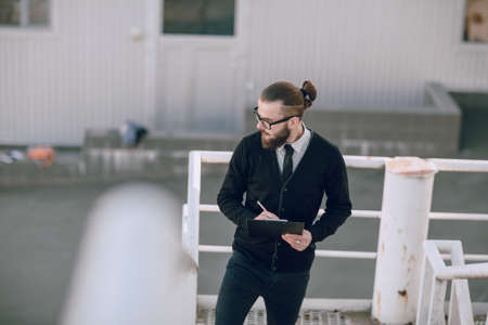 business man checking objects in glasses shirtの写真素材