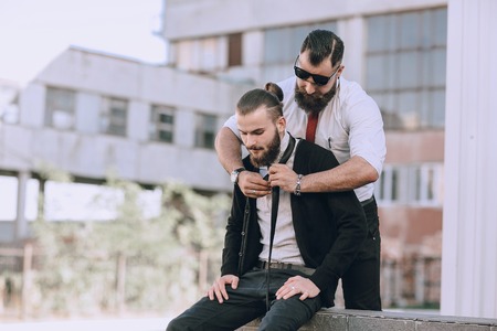 Two bearded men zavyazuyut hastuky each other outの写真素材