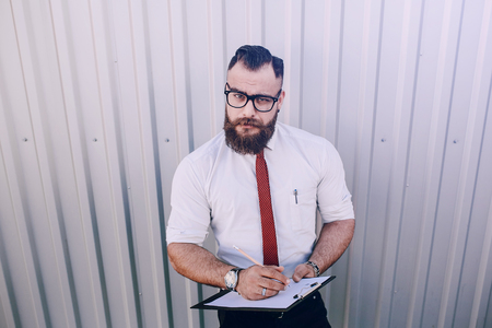 business man checking objects in glasses shirtの写真素材