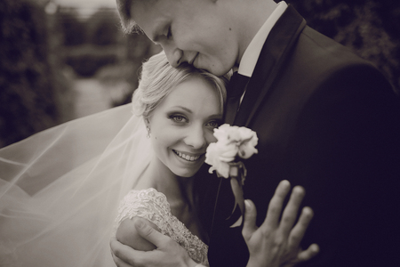 beautiful blond wedding couple walking on reserveの写真素材