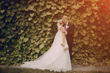 beautiful blond wedding couple walking on reserveの写真素材
