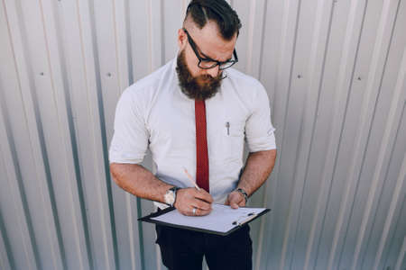 business man checking objects in glasses shirtの写真素材