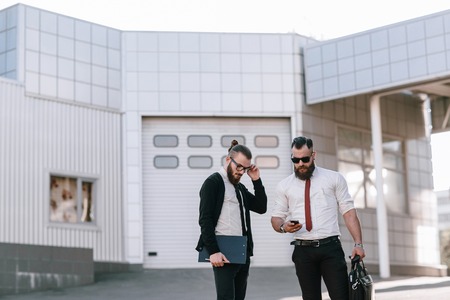 business man checking objects in glasses shirtの写真素材