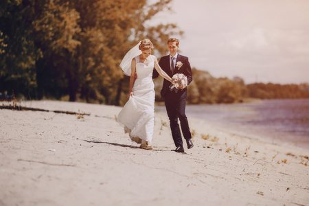 lovely blond summer wedding couple in sunny weatherの写真素材