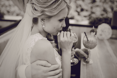 wedding couple sitting in a cafe on their wedding dayの写真素材