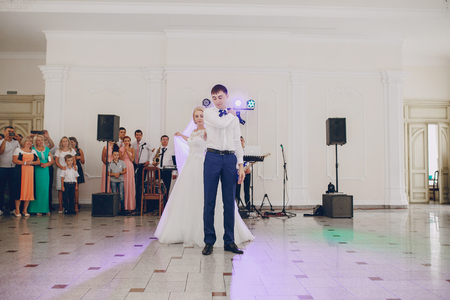 first dance of a young couple in a romantic restaurantの写真素材