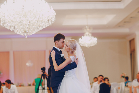 first dance of a young couple in a romantic restaurantの写真素材