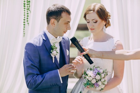 wedding ceremony charming couple in arch HDの写真素材