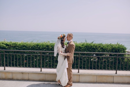 authentic wonderful young couple wedding bride in a wreath of flowers and decorationsの写真素材