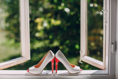 wonderful wedding tufliyaki standing on the window to natureの写真素材