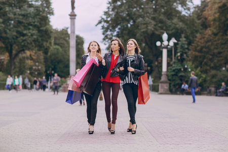 woman with returns from shopping with colored bags fashionの写真素材