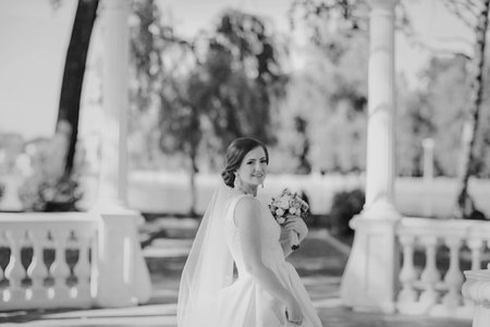 beautiful wedding couple on their wedding walking in the park in excellent weather conditionsの写真素材