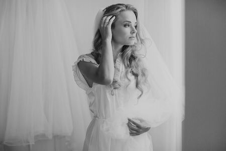 beautiful blonde bride preparing for her weddingの写真素材