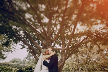 beautiful blond wedding couple walking on reserveの写真素材