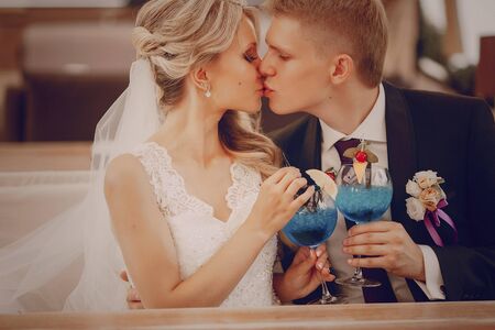 wedding couple sitting in a cafe on their wedding dayの写真素材