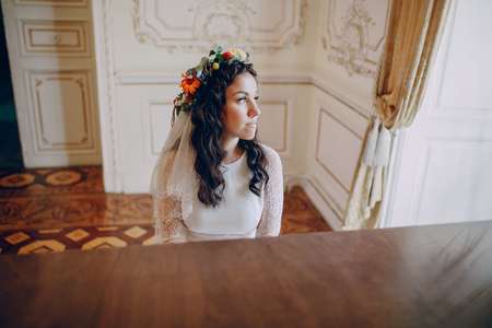 charming wedding couple playing on an old piano in the roomの写真素材