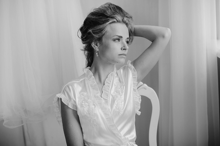 beautiful blonde bride preparing for her weddingの写真素材