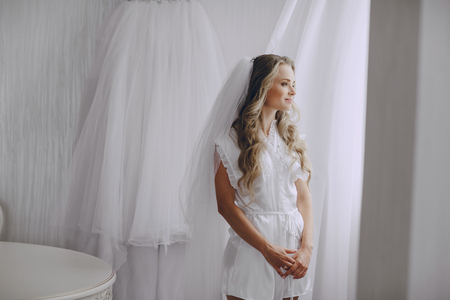 beautiful blonde bride preparing for her weddingの写真素材