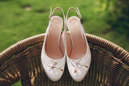 gorgeous wedding shoes for the bride on a background of green grassの写真素材