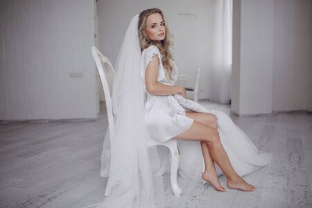 beautiful blonde bride preparing for her weddingの写真素材