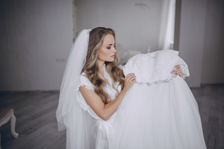 beautiful blonde bride preparing for her weddingの写真素材