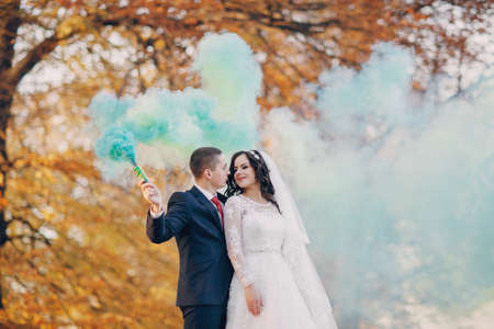 beautiful wedding couple celebrating their wedding day in autumnの写真素材