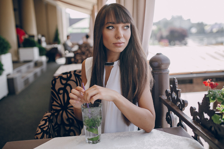 butifull girl drinks mojito outside  sunni weatherの写真素材