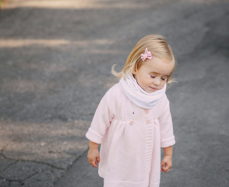 great trendy young mothers walking in the park with his daughters in beautiful clothing