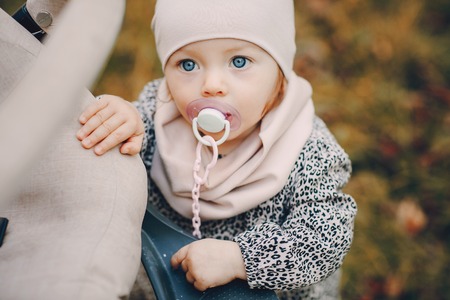 great trendy young mothers walking in the park with his daughters in beautiful clothingの写真素材
